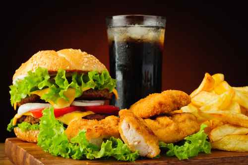 Burger, chicken nuggets, french fries and cola drink